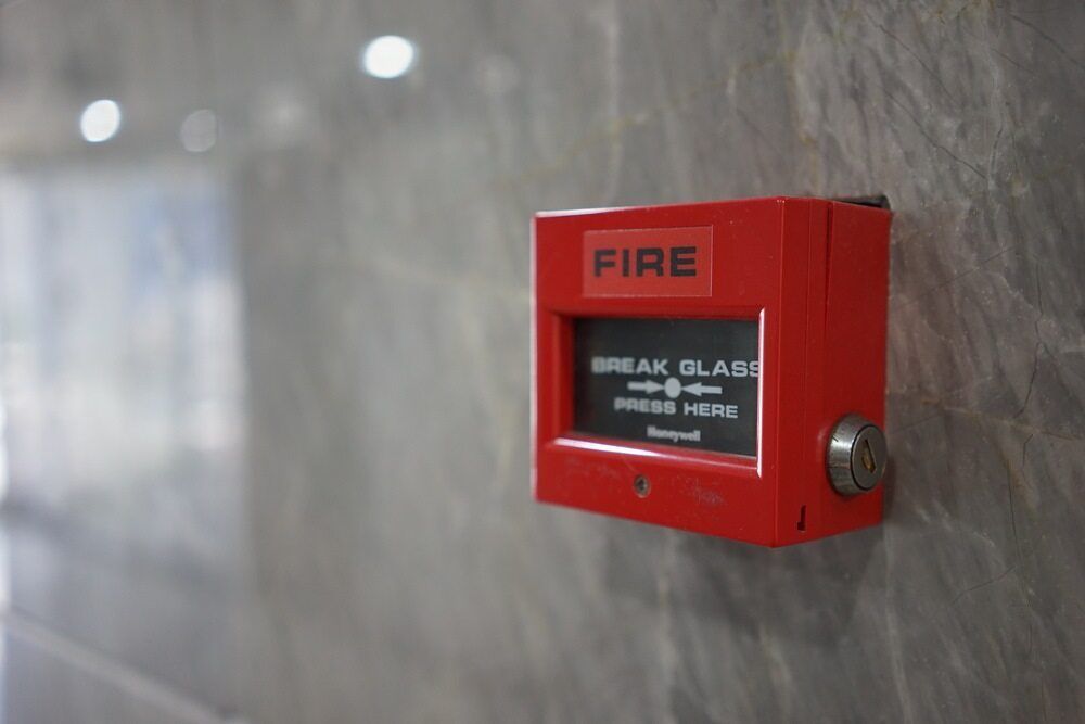 A Red Fire Alarm Is Hanging On A Wall — Firewerx In Forbes, NSW