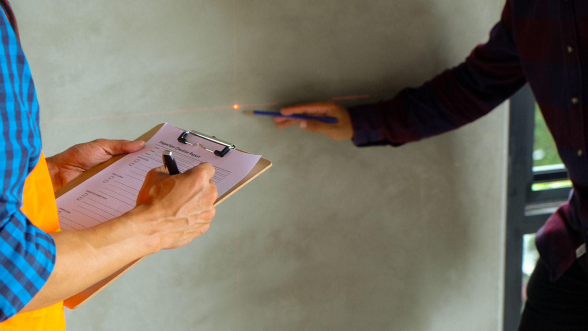 A Man Is Writing On A Clipboard While Another Man Holds A Pen — Firewerx In Dubbo, NSW