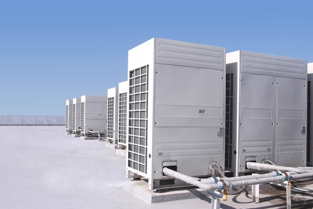 A row of air conditioners are sitting on top of a roof — Firewerx In Dubbo, NSW