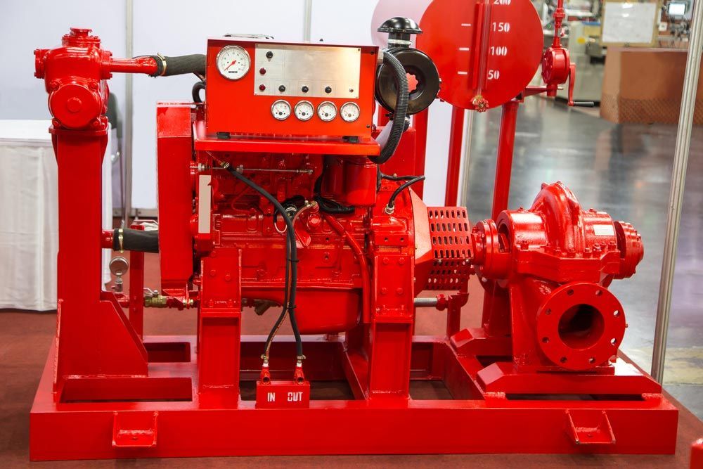 A Red Engine And Pump Are On Display In A Warehouse — Firewerx In Dubbo, NSW