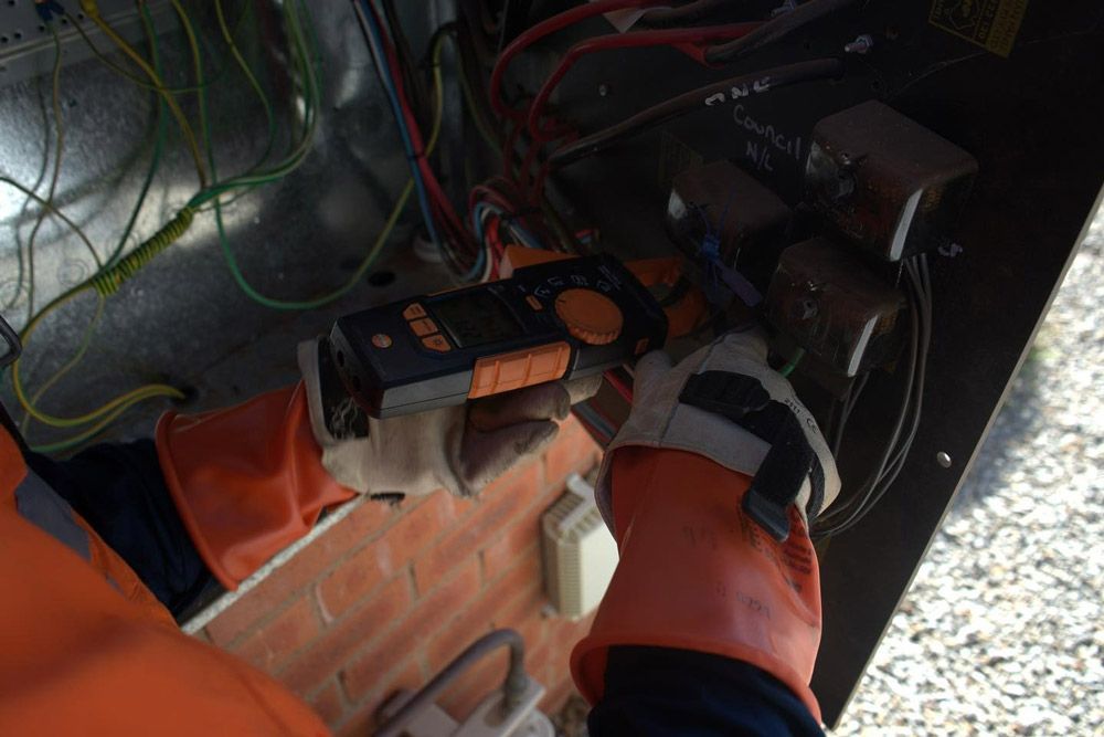A Person Wearing Orange Gloves Is Working On A Machine — Firewerx In Dubbo, NSW