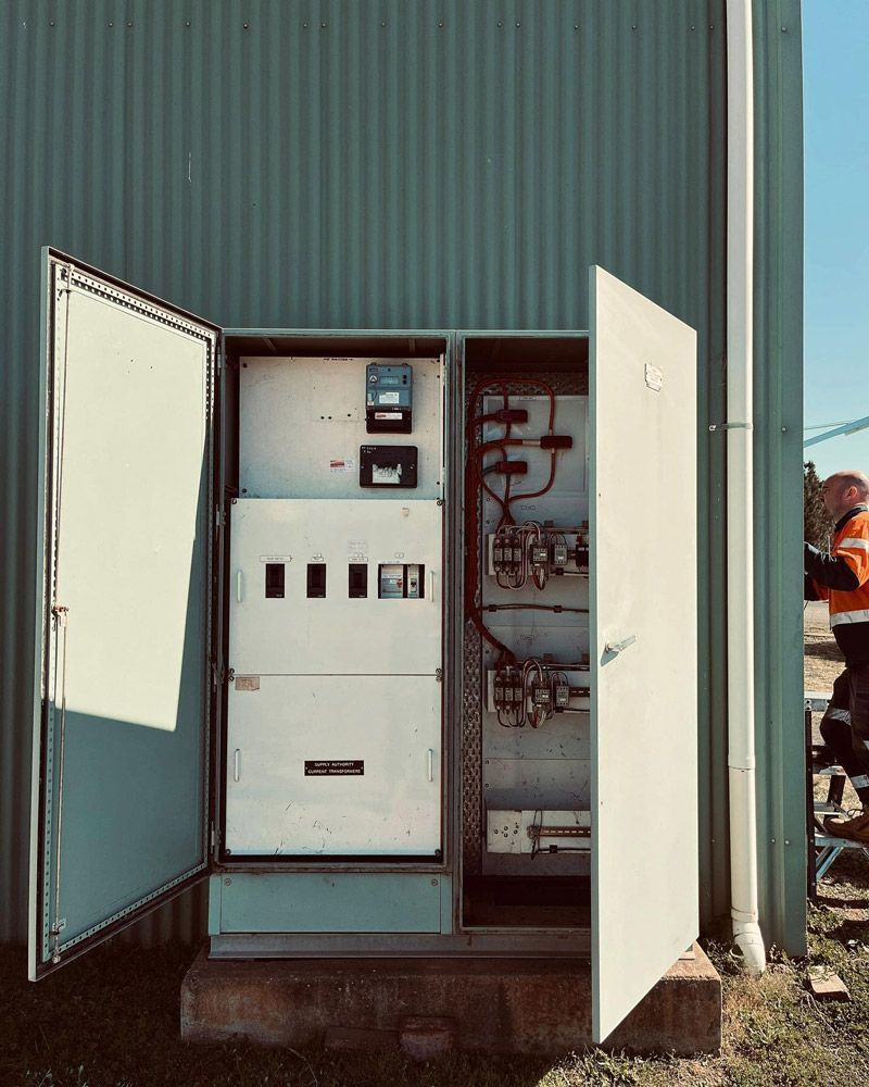A Large Electrical Box Is Sitting Outside Of A Building With Its Doors Open — Firewerx In Dubbo, NSW