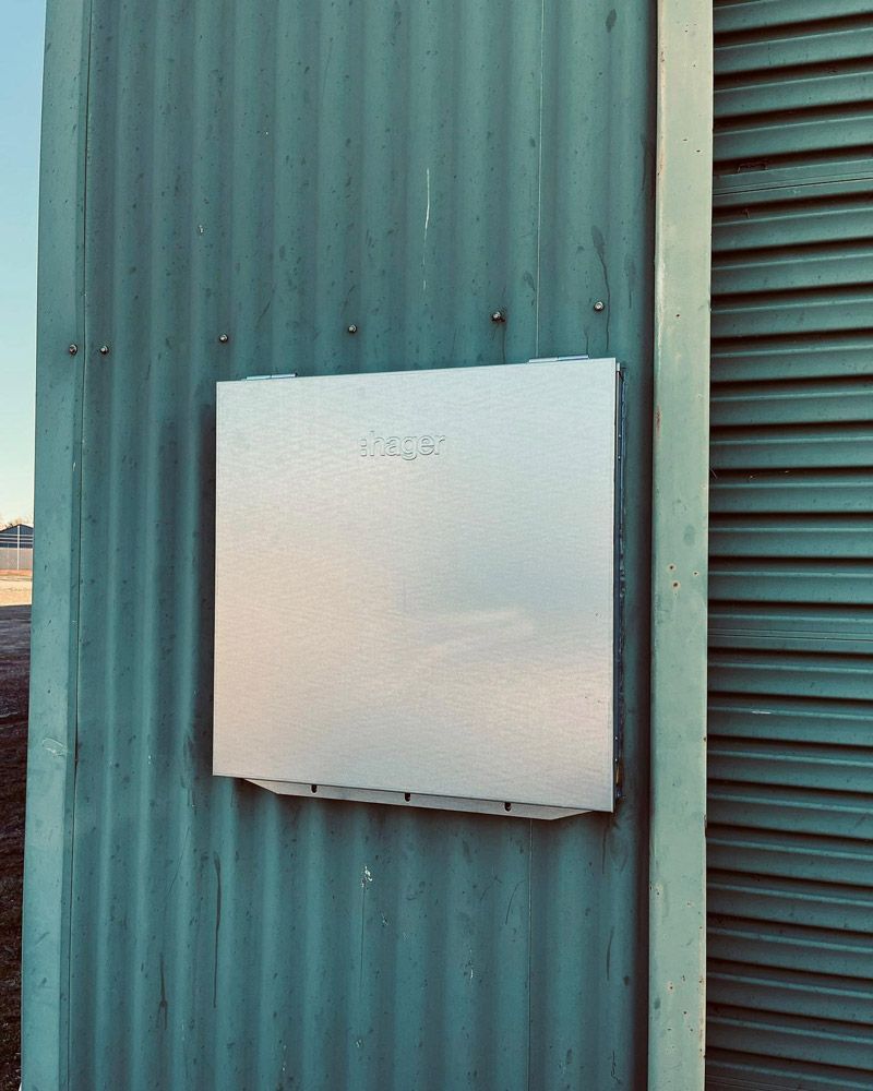 A White Box Is Sitting On The Side Of A Building — Firewerx In Orange, NSW