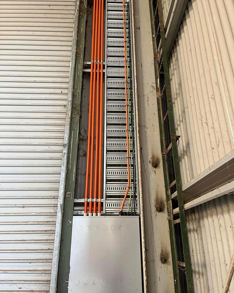 A Bunch Of Wires Are Hanging From The Ceiling Of A Building — Firewerx In Dubbo, NSW