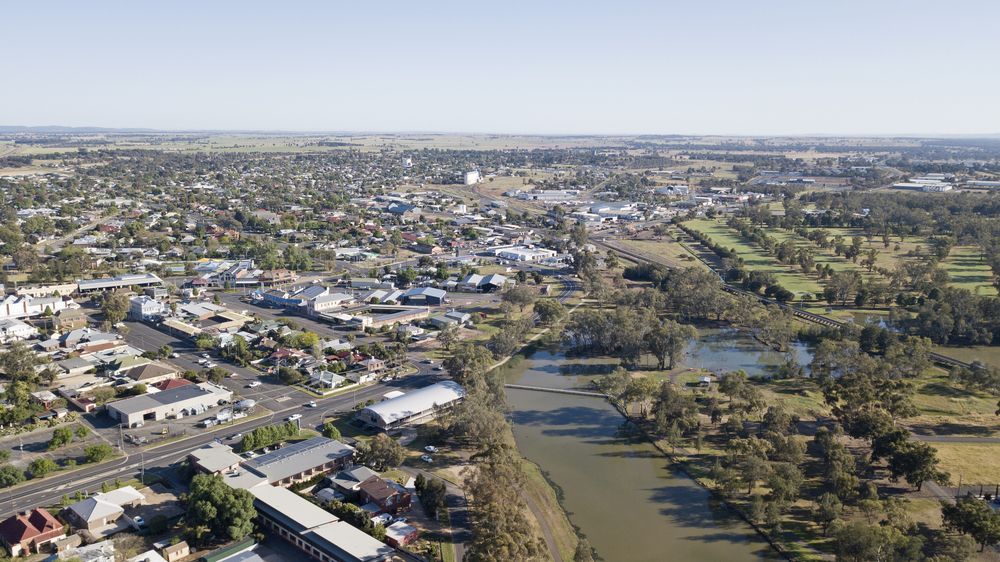 An Aerial View Of A City Surrounded By Trees And A River — Firewerx In Forbes, NSW