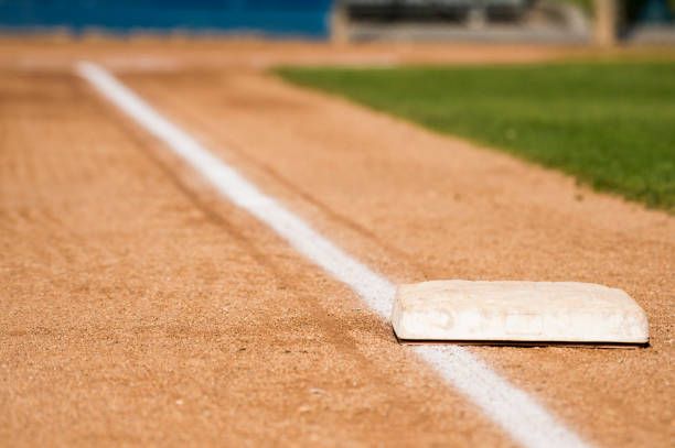 A close up of a base on a baseball field.