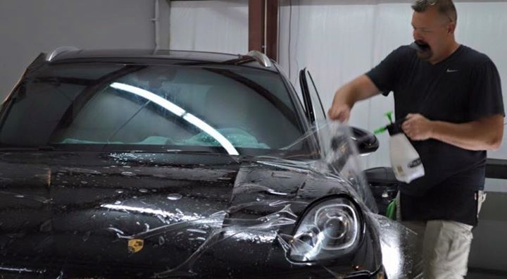 Last Coating — Man Working On A Black Porsche in Asheville, NC