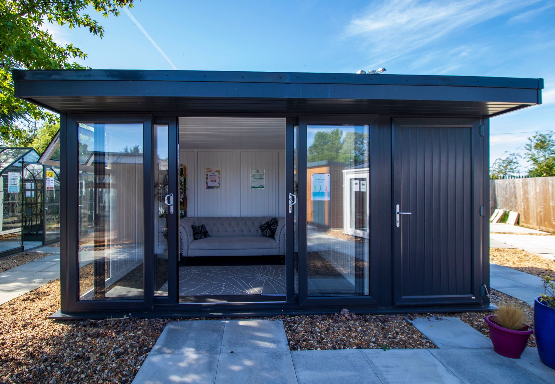A small house with a couch and sliding glass doors.