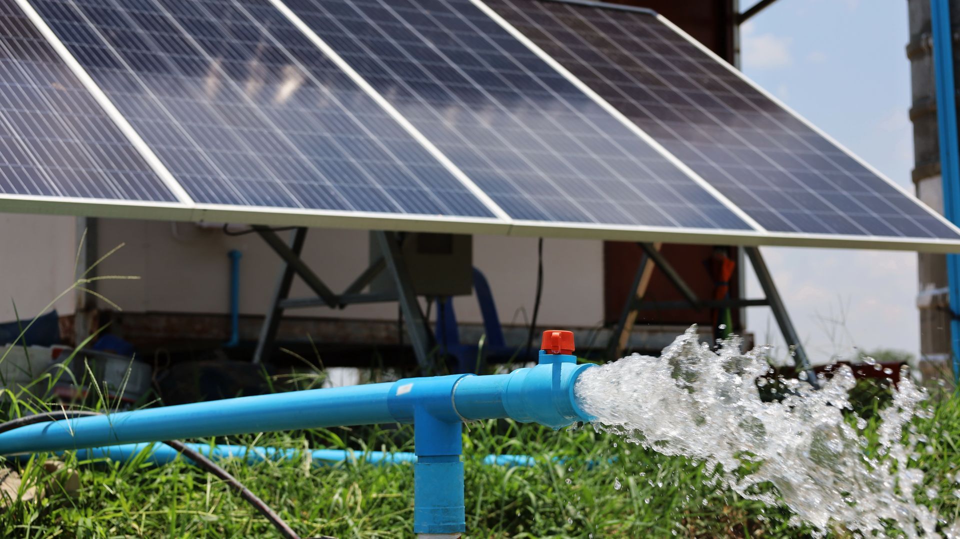 A solar panel is being used to pump water from a pipe.