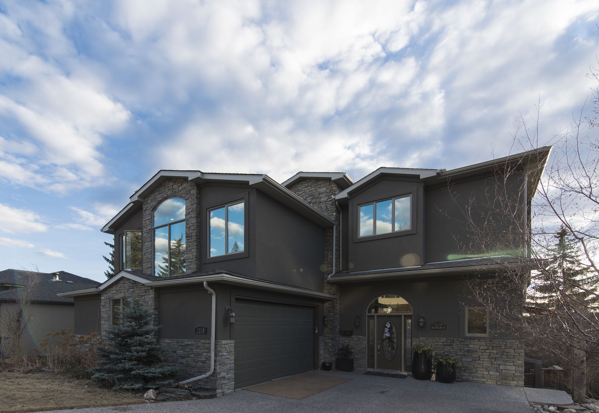 A large black house with a lot of windows