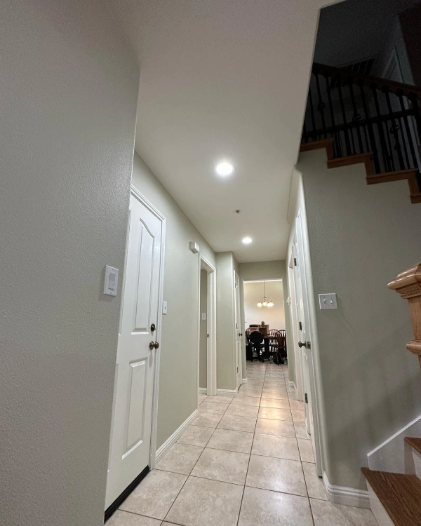 A hallway with stairs leading up to the second floor of a house.