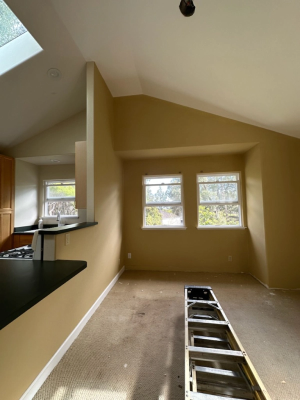 An empty room with a ladder in the middle of it