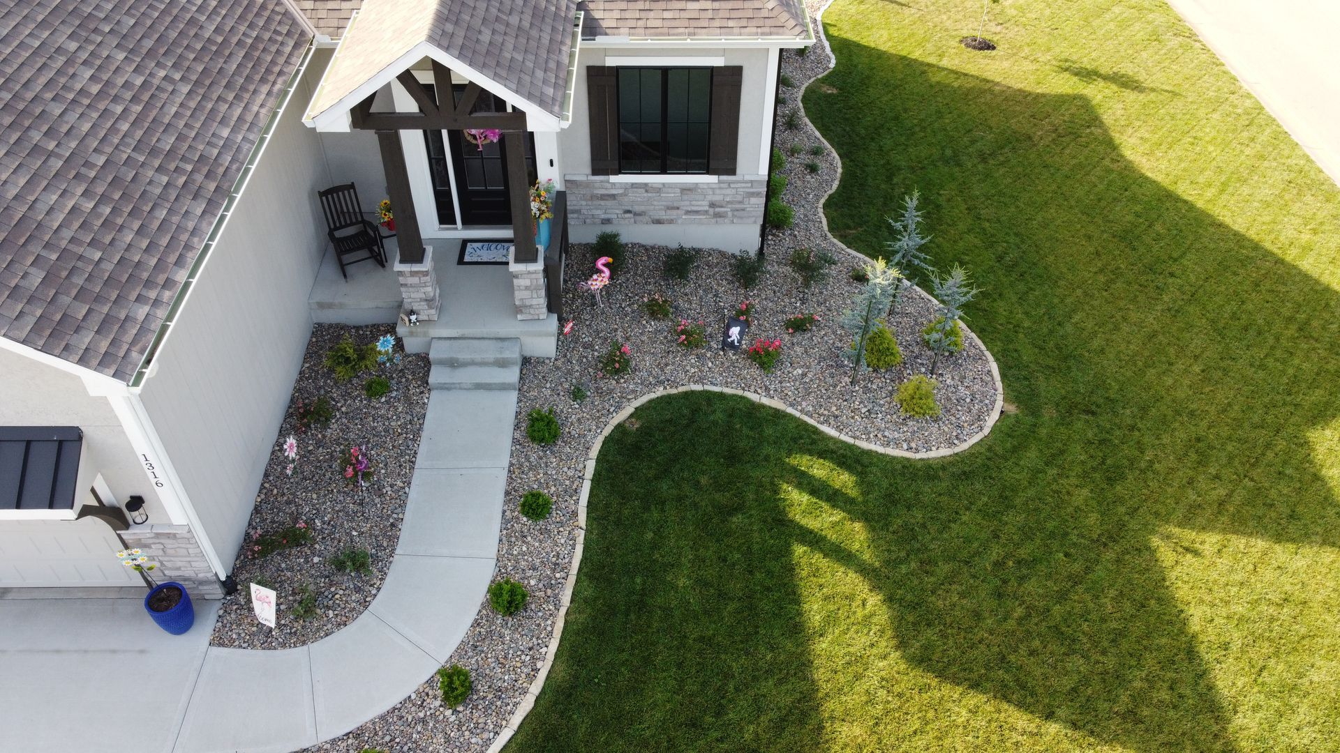 An aerial view of a house with a lush green lawn.