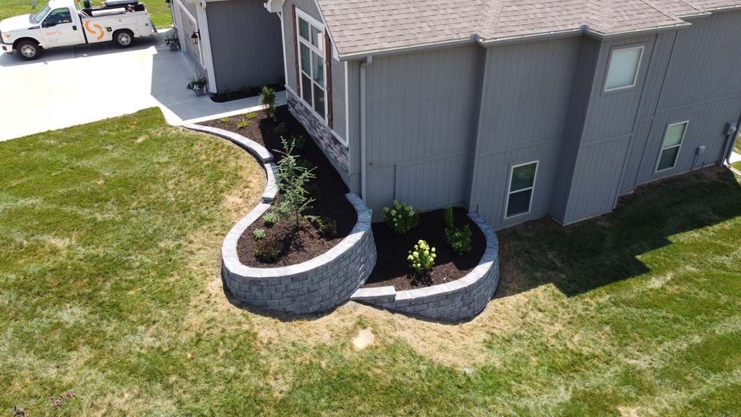 An aerial view of a house with a planter in front of it.