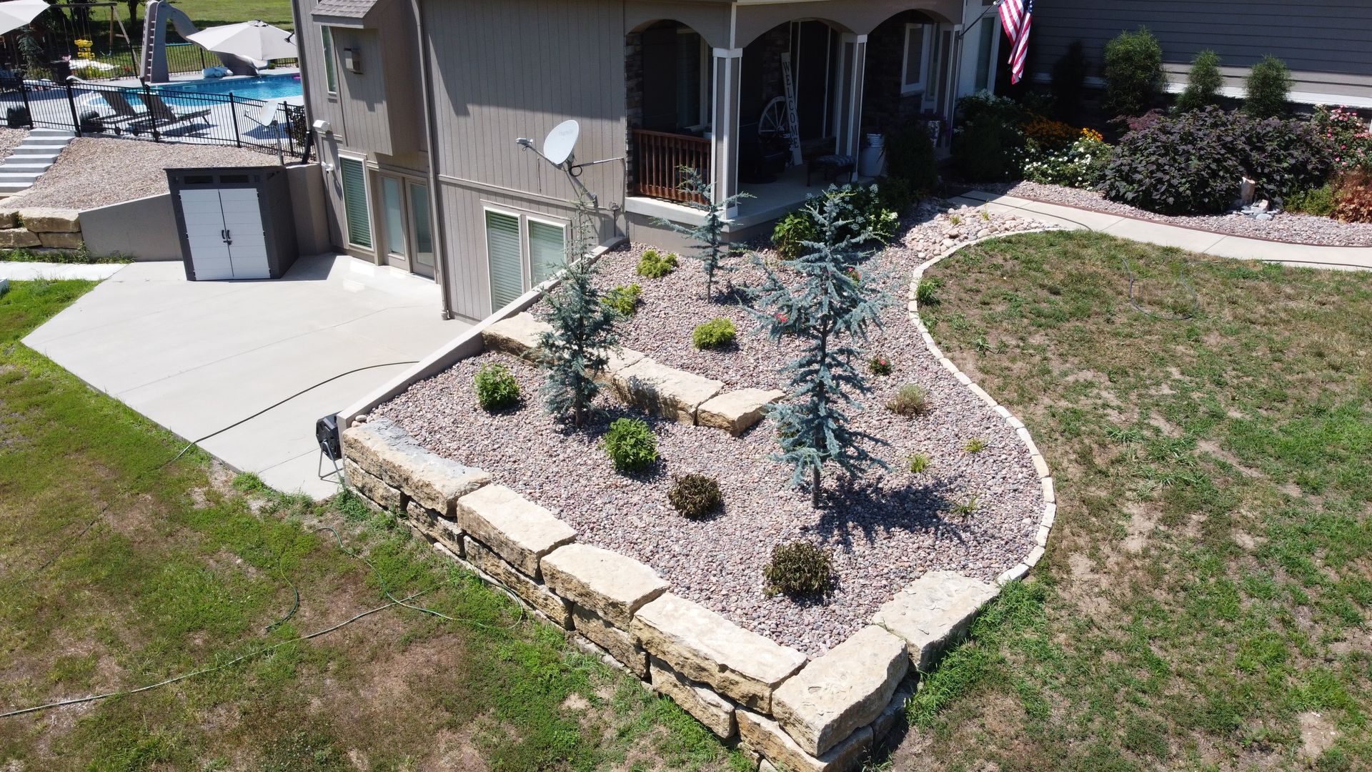 An aerial view of a house with a garden in front of it.