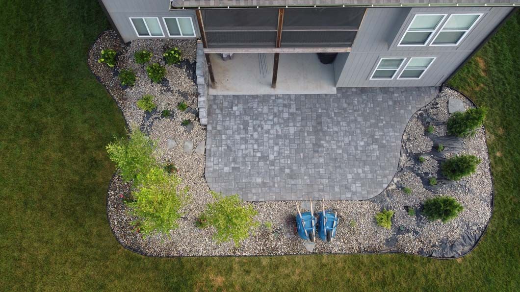 An aerial view of a house with a patio in front of it.