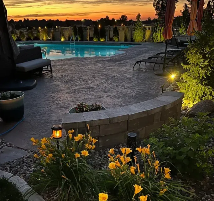 A swimming pool with a sunset in the background