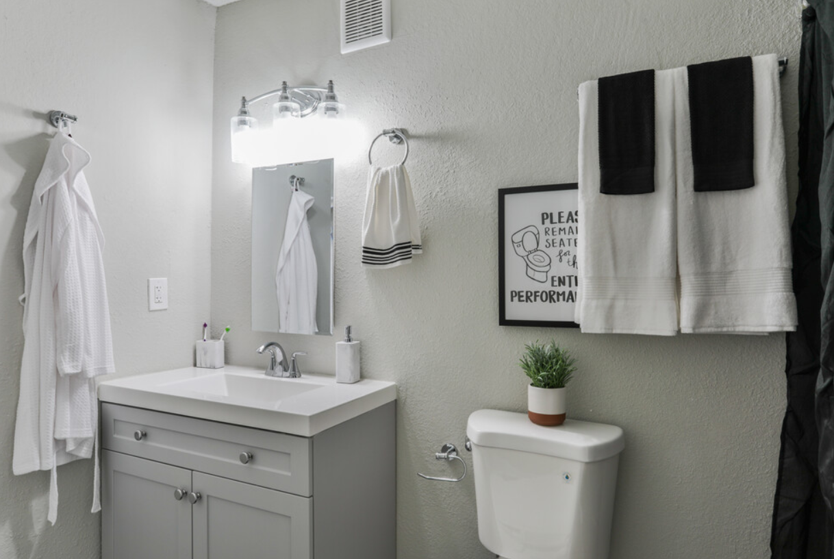 A bathroom with a sink , toilet , and mirror.
