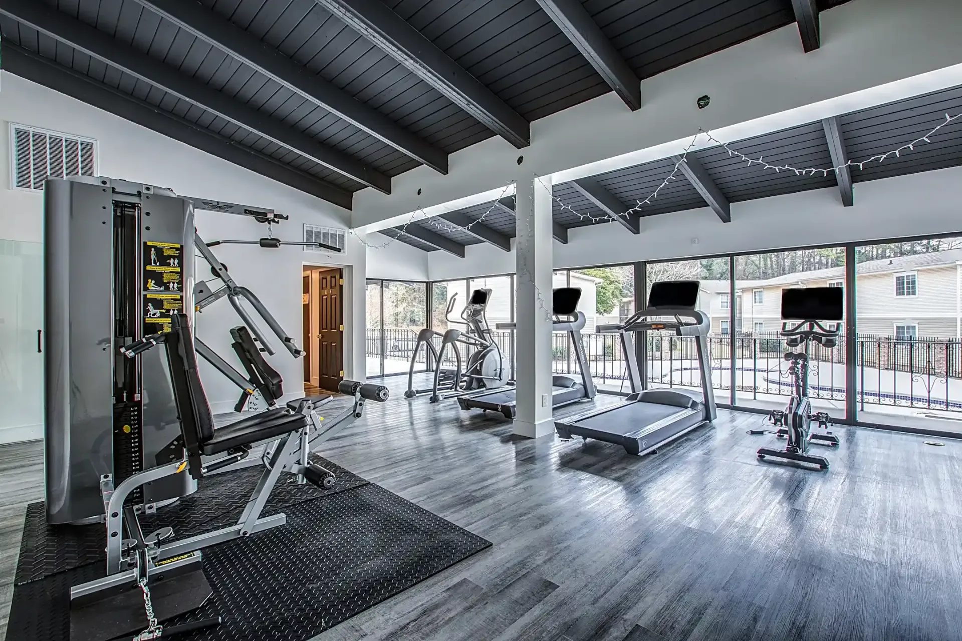 A large gym with a lot of equipment and a lot of windows.