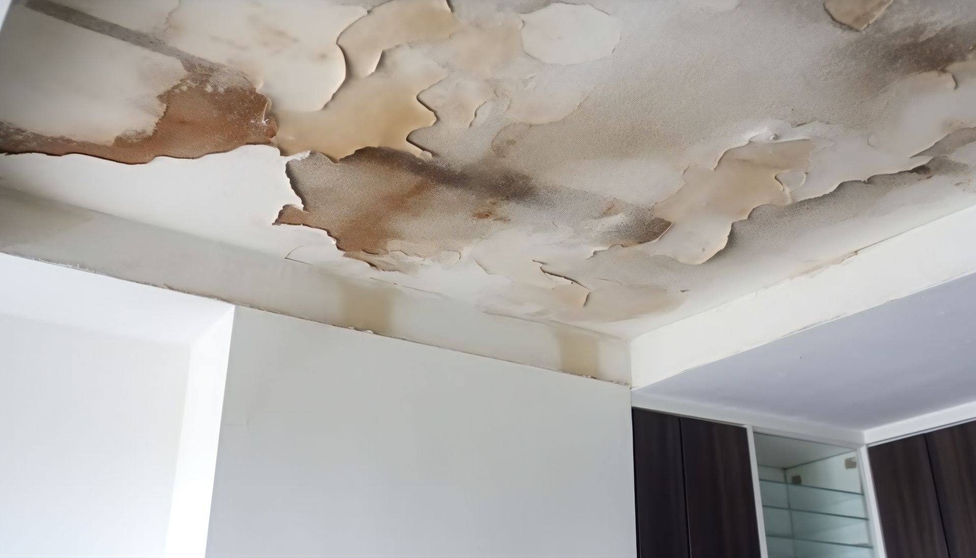 Leaking roof causes severe water damage, needing immediate emergency water damage restoration.