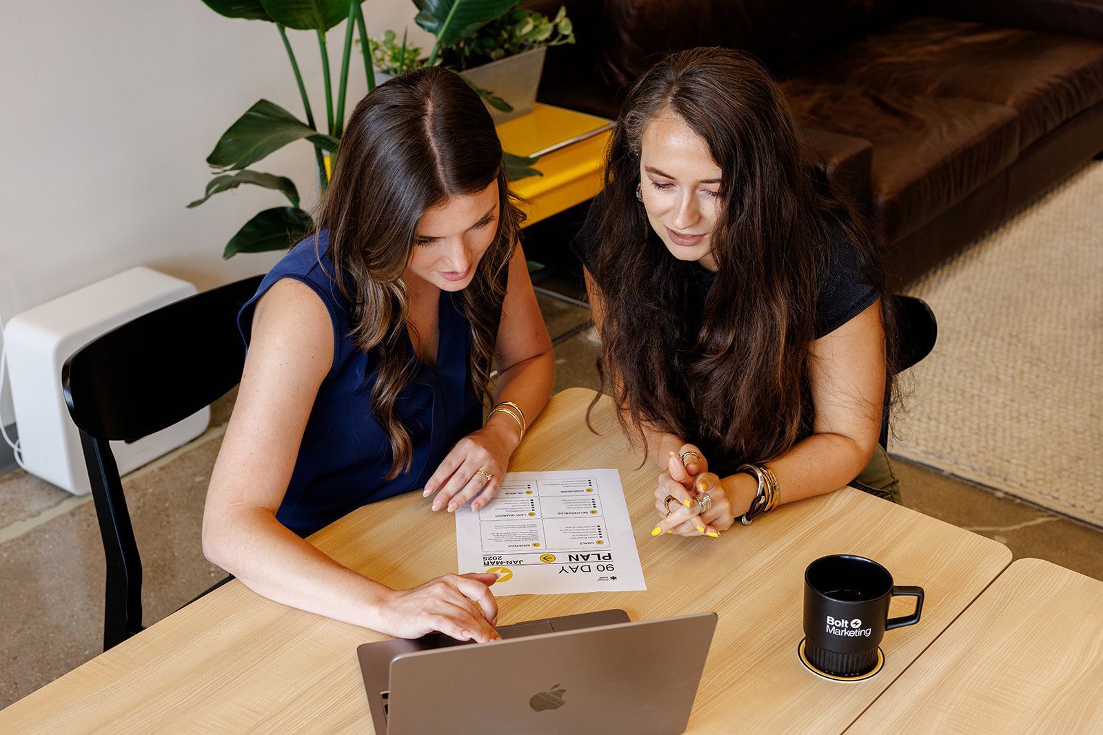 A man and a woman are sitting at a table having a conversation.