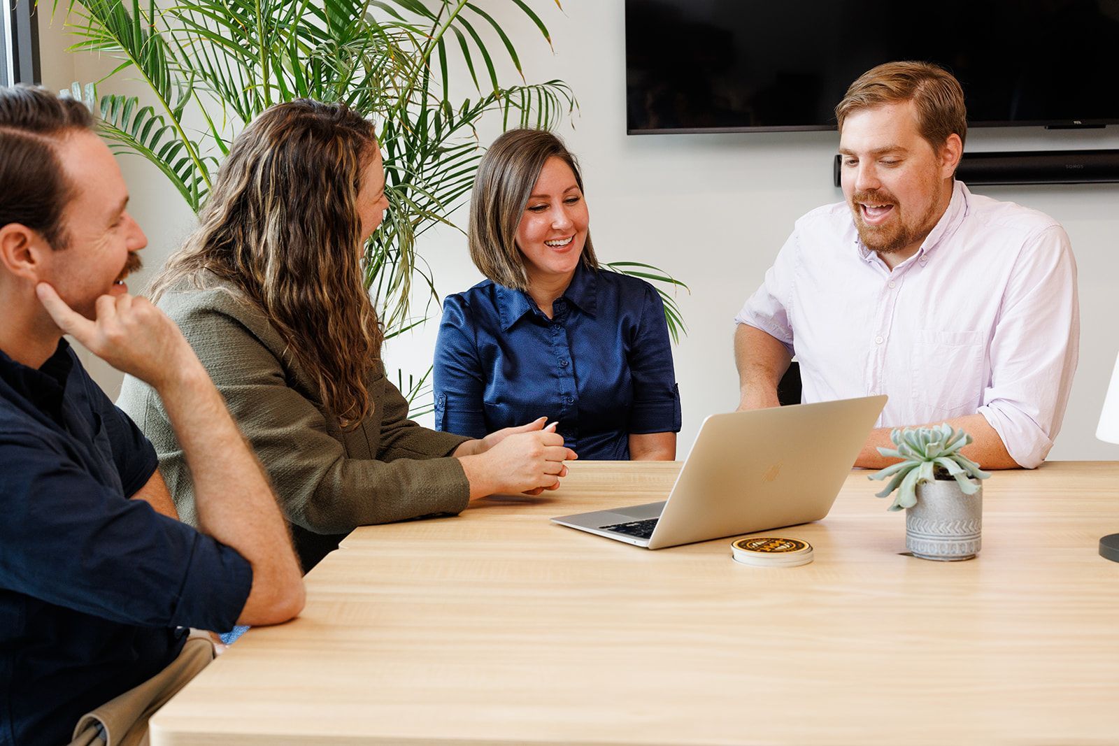 A man and a woman are sitting at a table having a conversation.