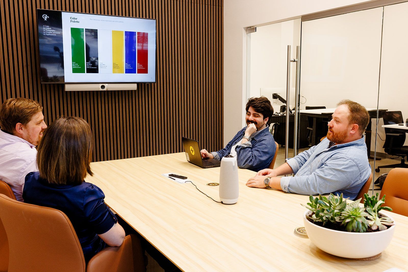 A woman is sitting at a desk working on a computer.