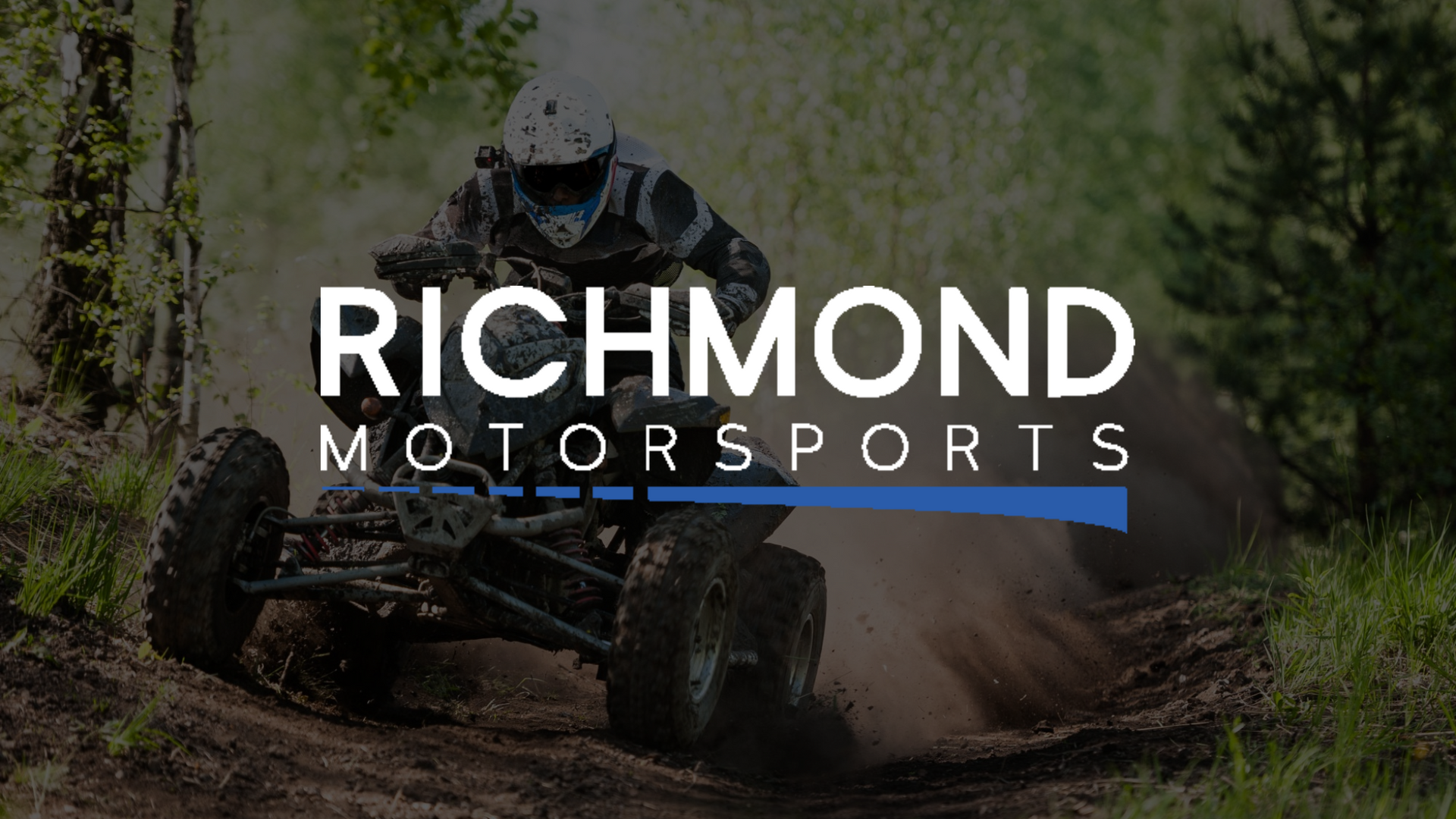 A person is riding an atv on a dirt road.