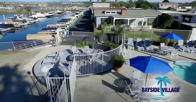 Aerial view of spa area and home in front of the marina in Bayside Village