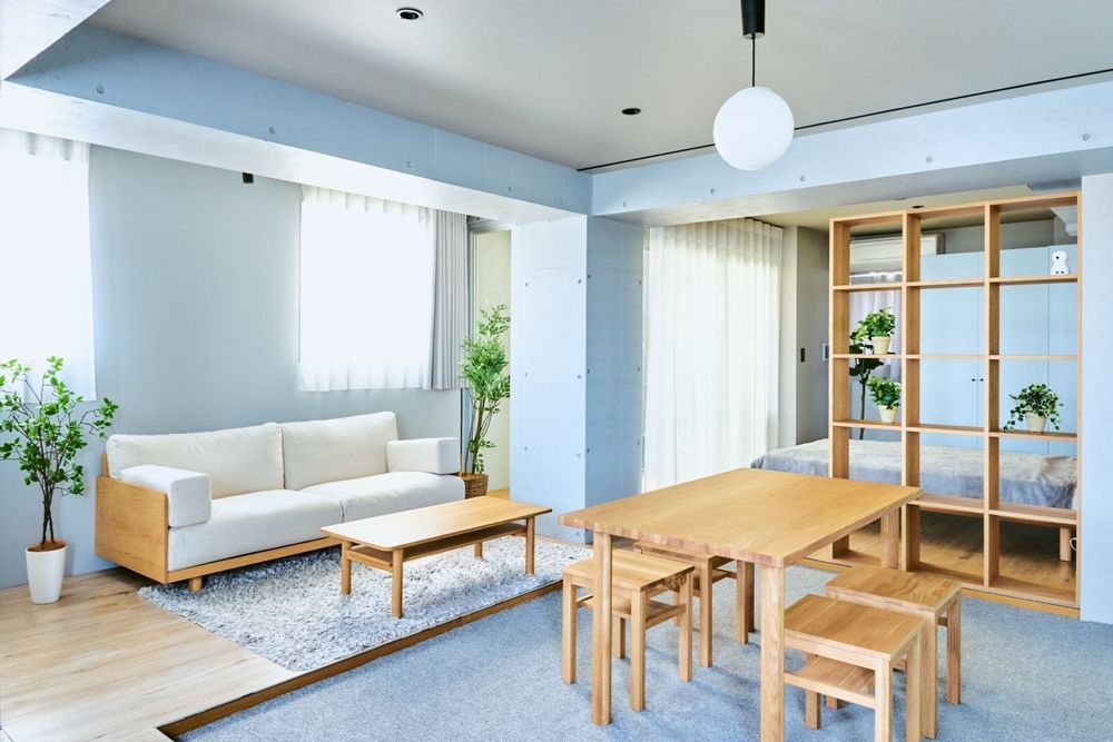 A living room with a couch , table and chairs.