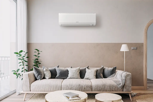 A living room with a couch , table , and air conditioner.