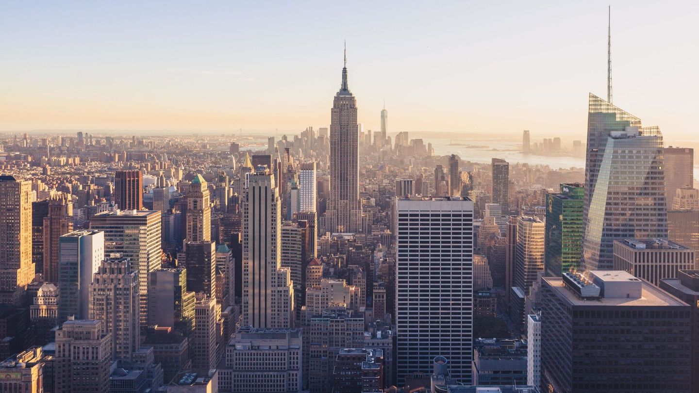 An aerial view of the skyline of new york city at sunset.