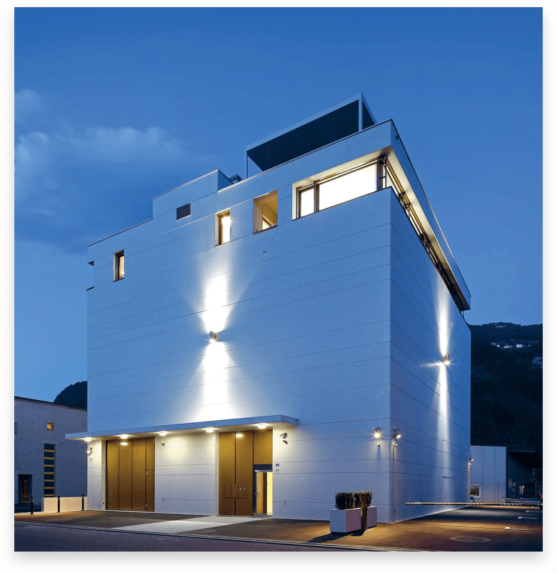 A large white building is lit up at night