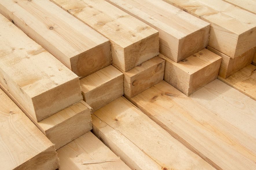 A pile of wooden beams stacked on top of each other.