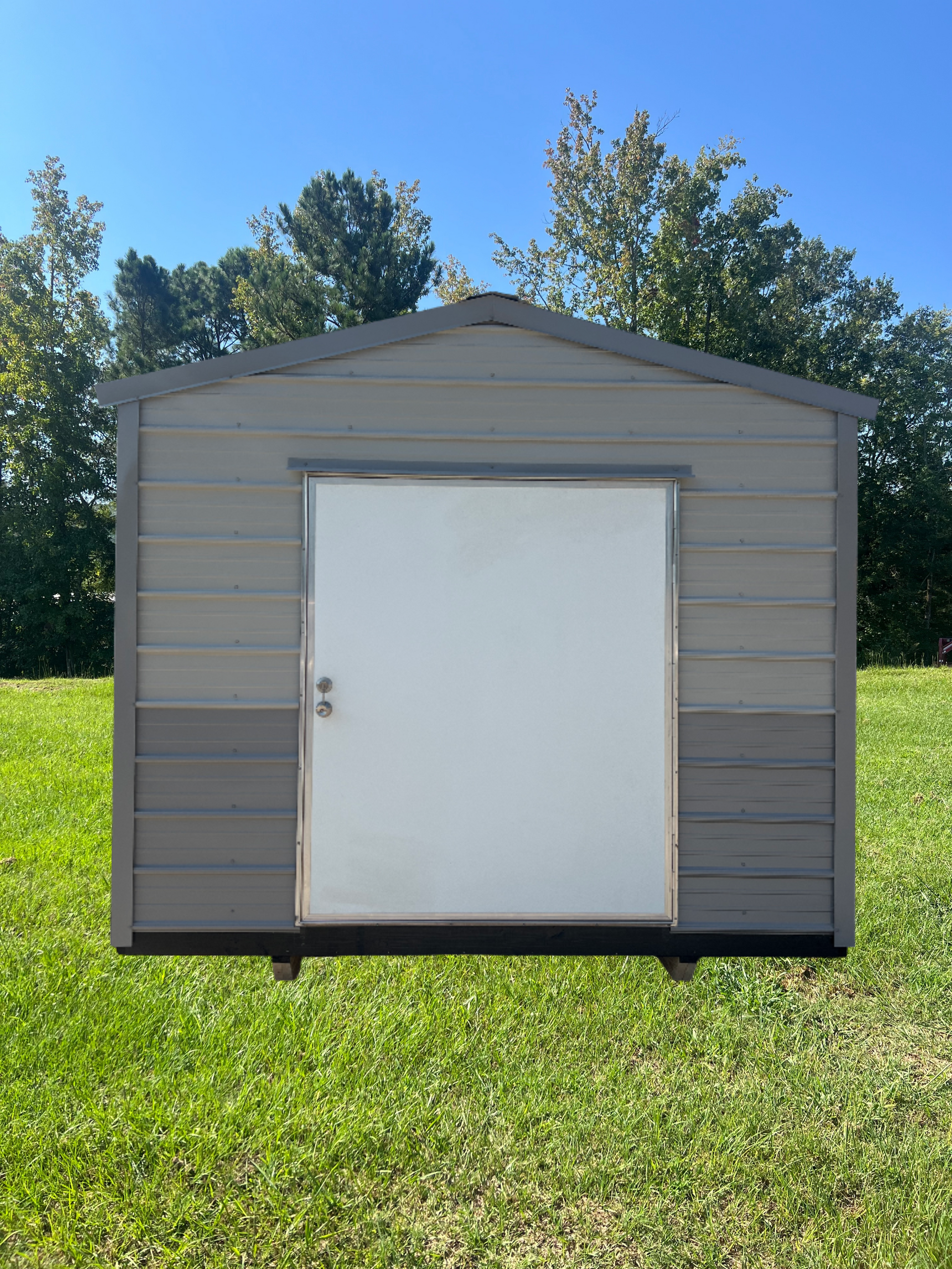 Gray metal shed with a black trim and door;