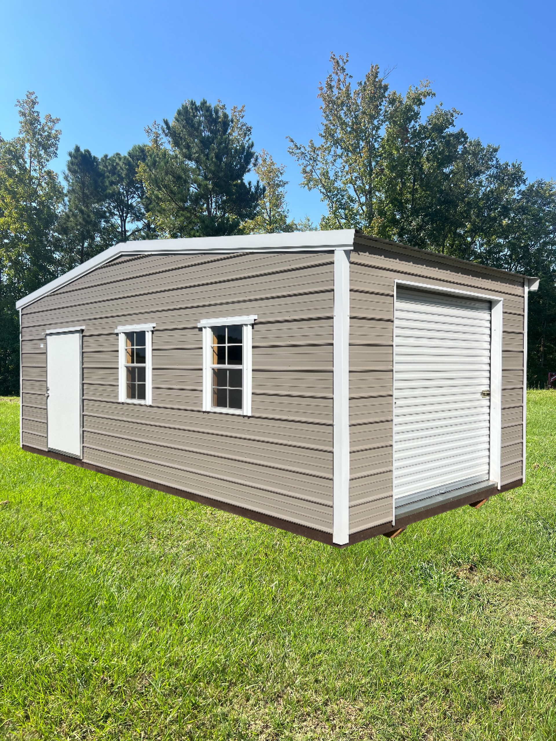 Tan metal shed with white trim, door, and garage door, in a grassy yard.