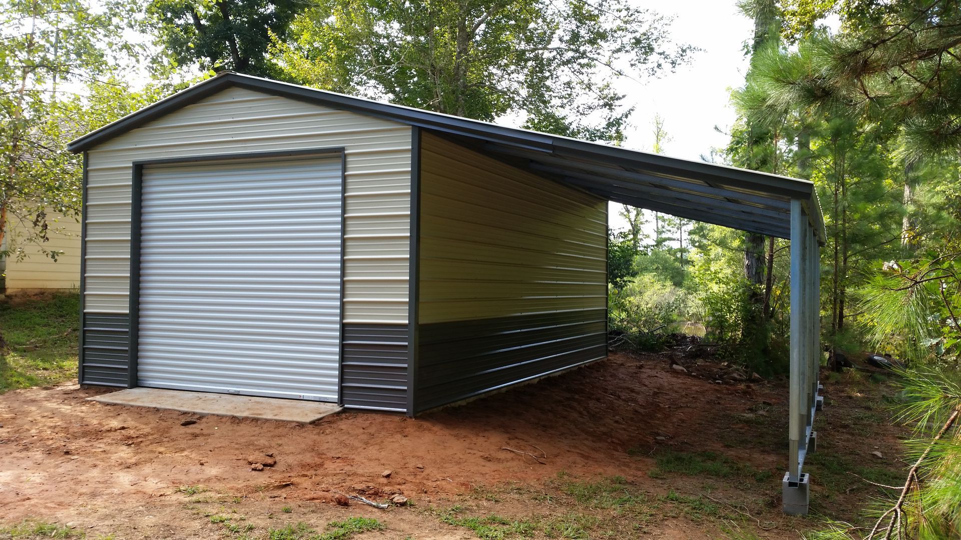 Metal shed with a carport extension, beige and dark brown panels, gray garage door, set outdoors.