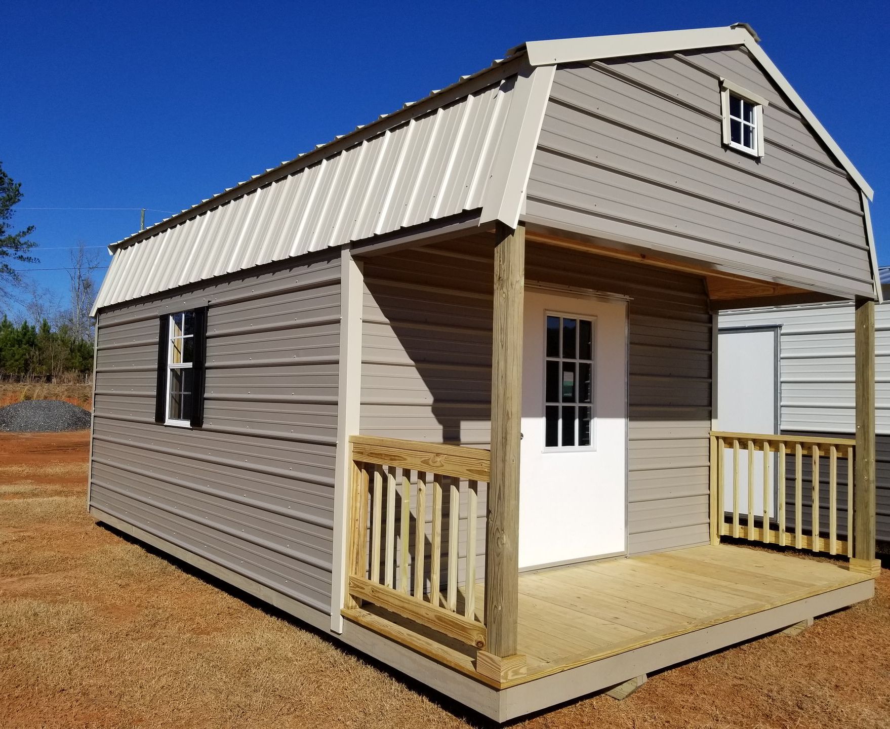 A small house with a porch and a window