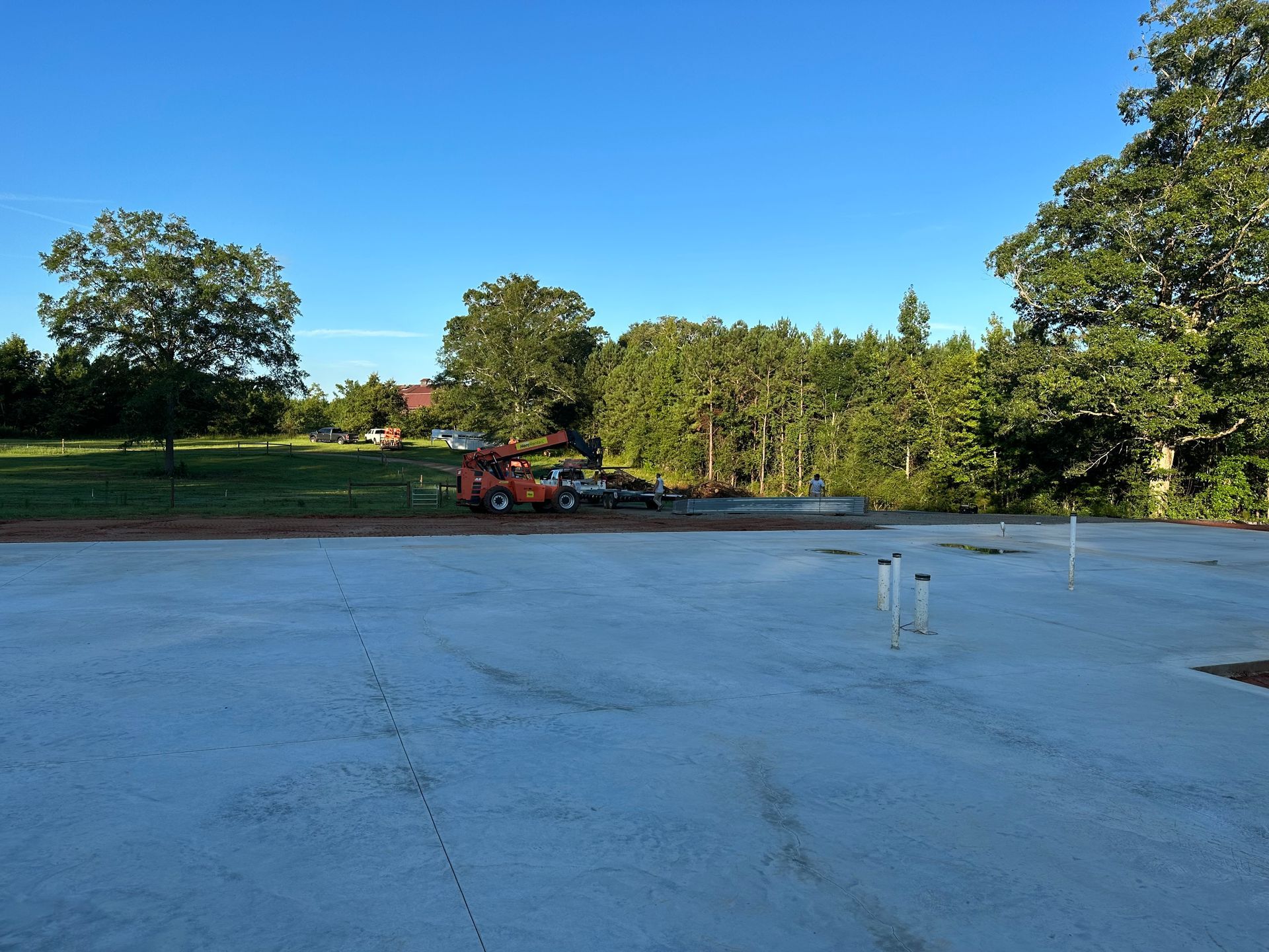 A large concrete area with trees in the background