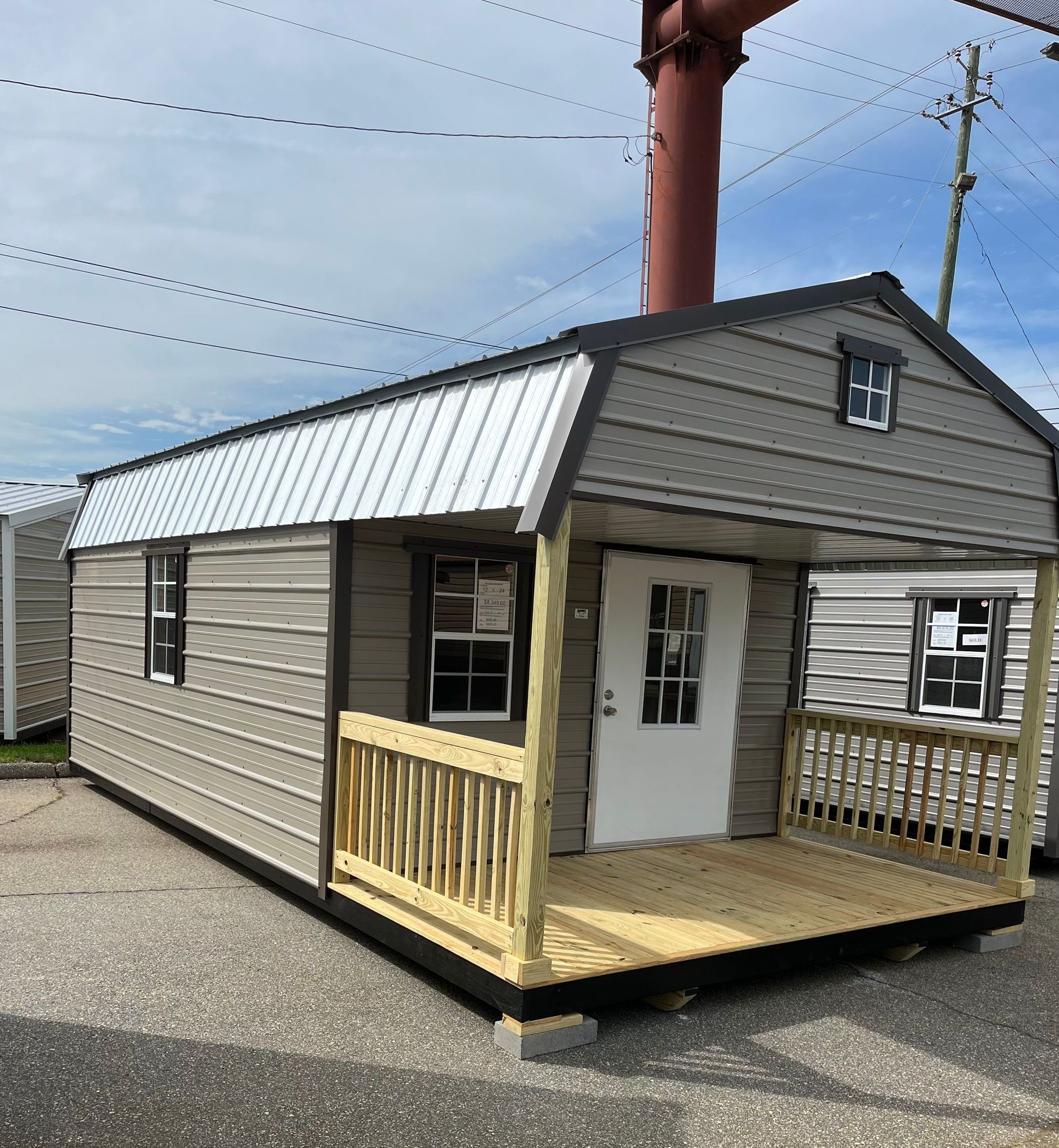 A small house with a porch and a white door
