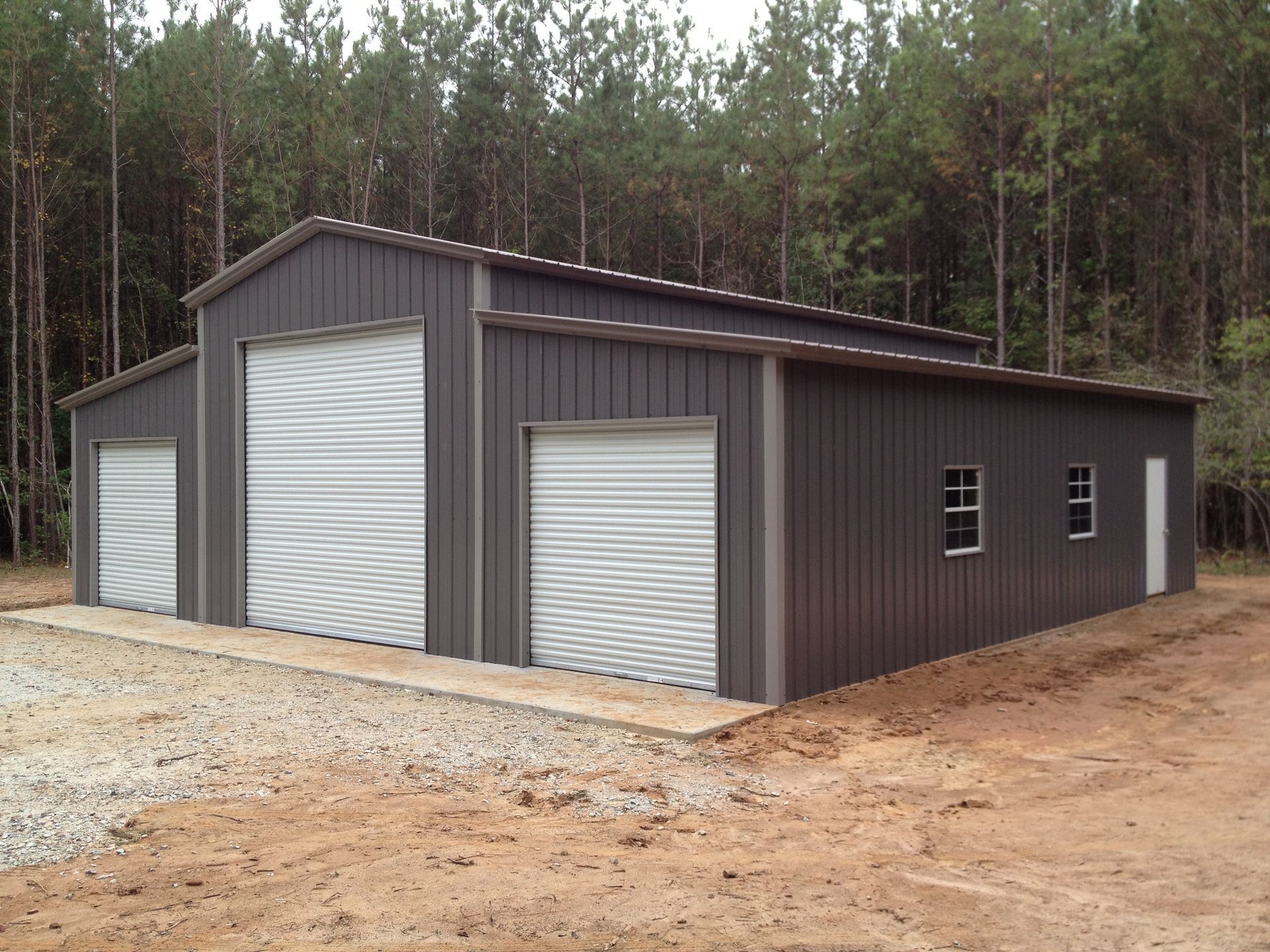 A large building with a lot of windows and garage doors