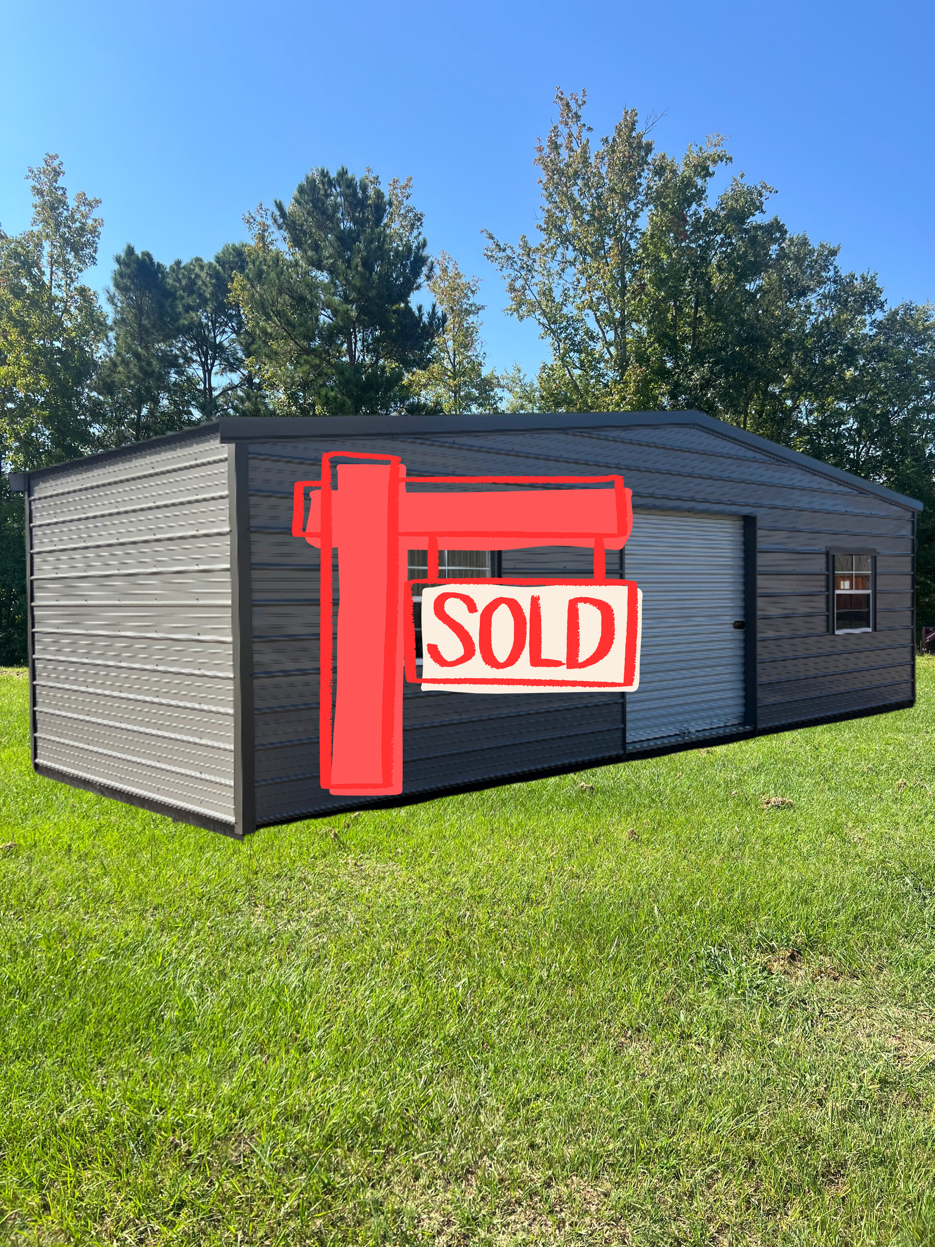 Black shed in a grassy yard with a red “SOLD” sign on the front.
