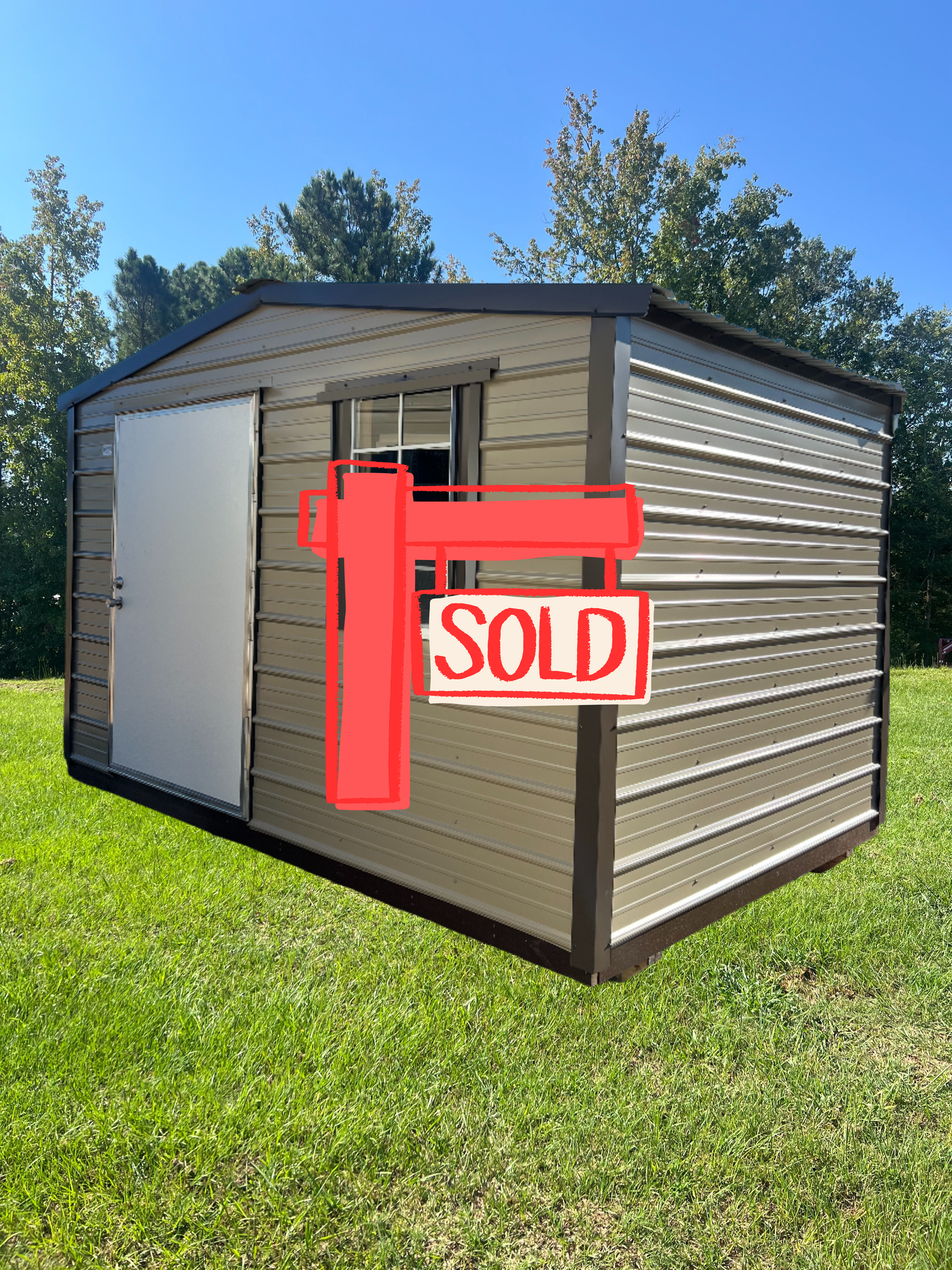 Tan and brown metal shed with a white door and small window, set on a green lawn.
