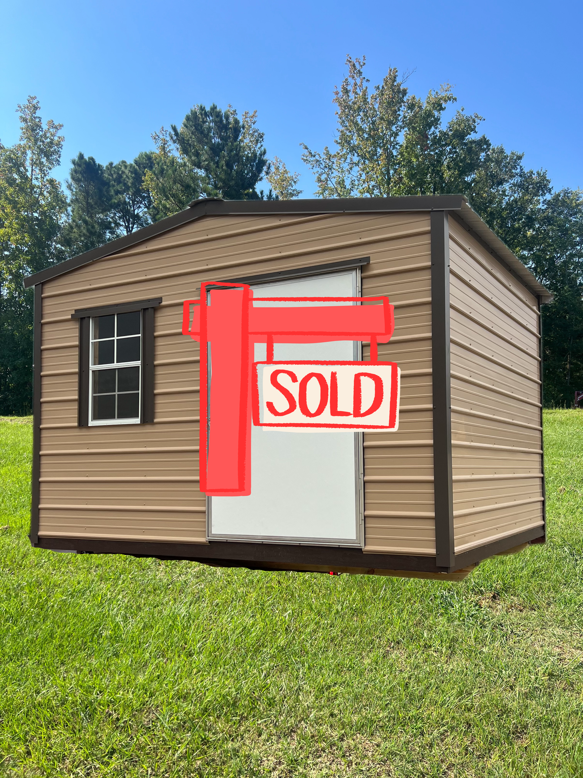 Tan outdoor storage shed with a window and white door, situated on a grassy lawn under a clear blue sky.