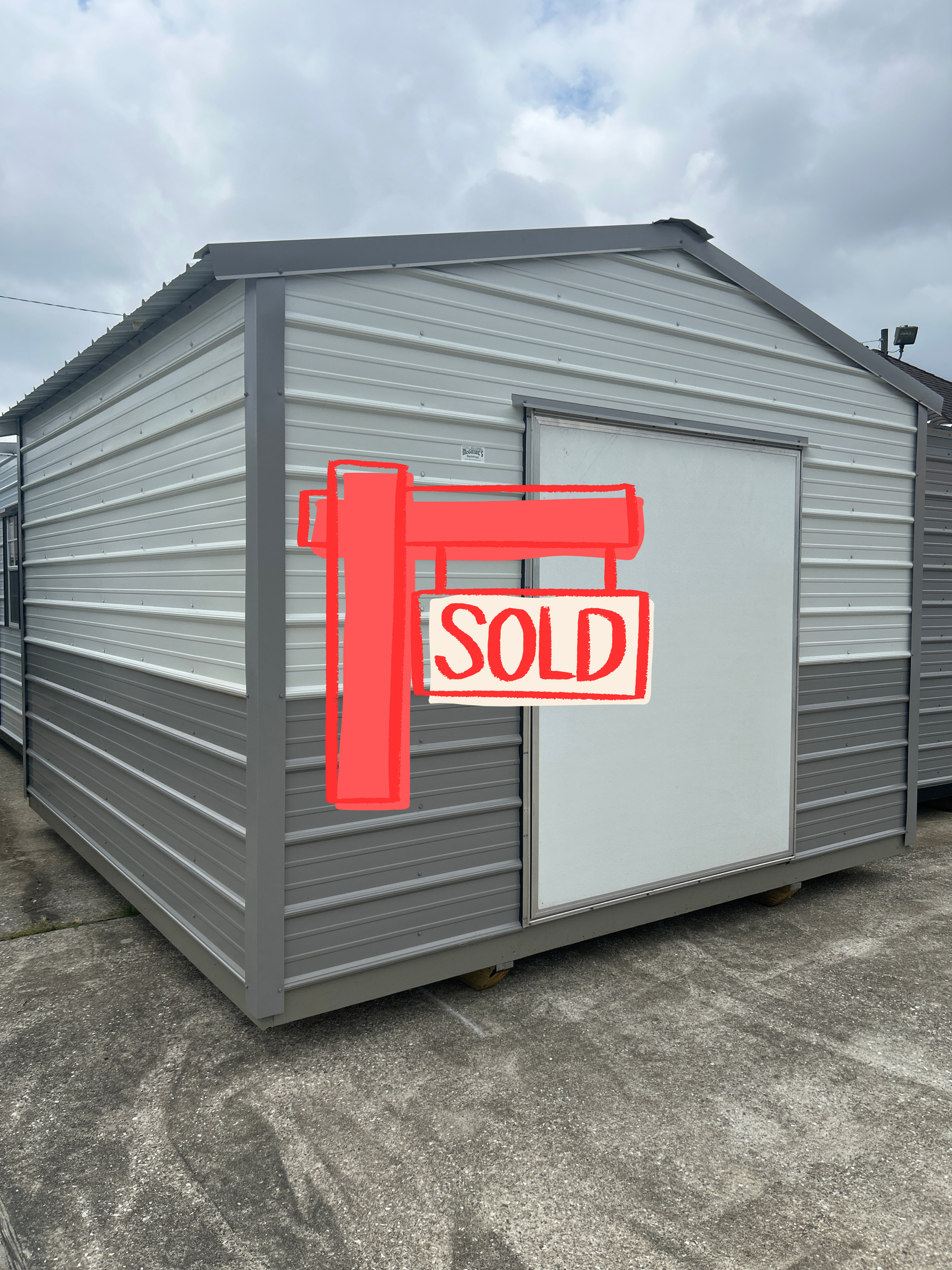 Gray metal shed with a red 