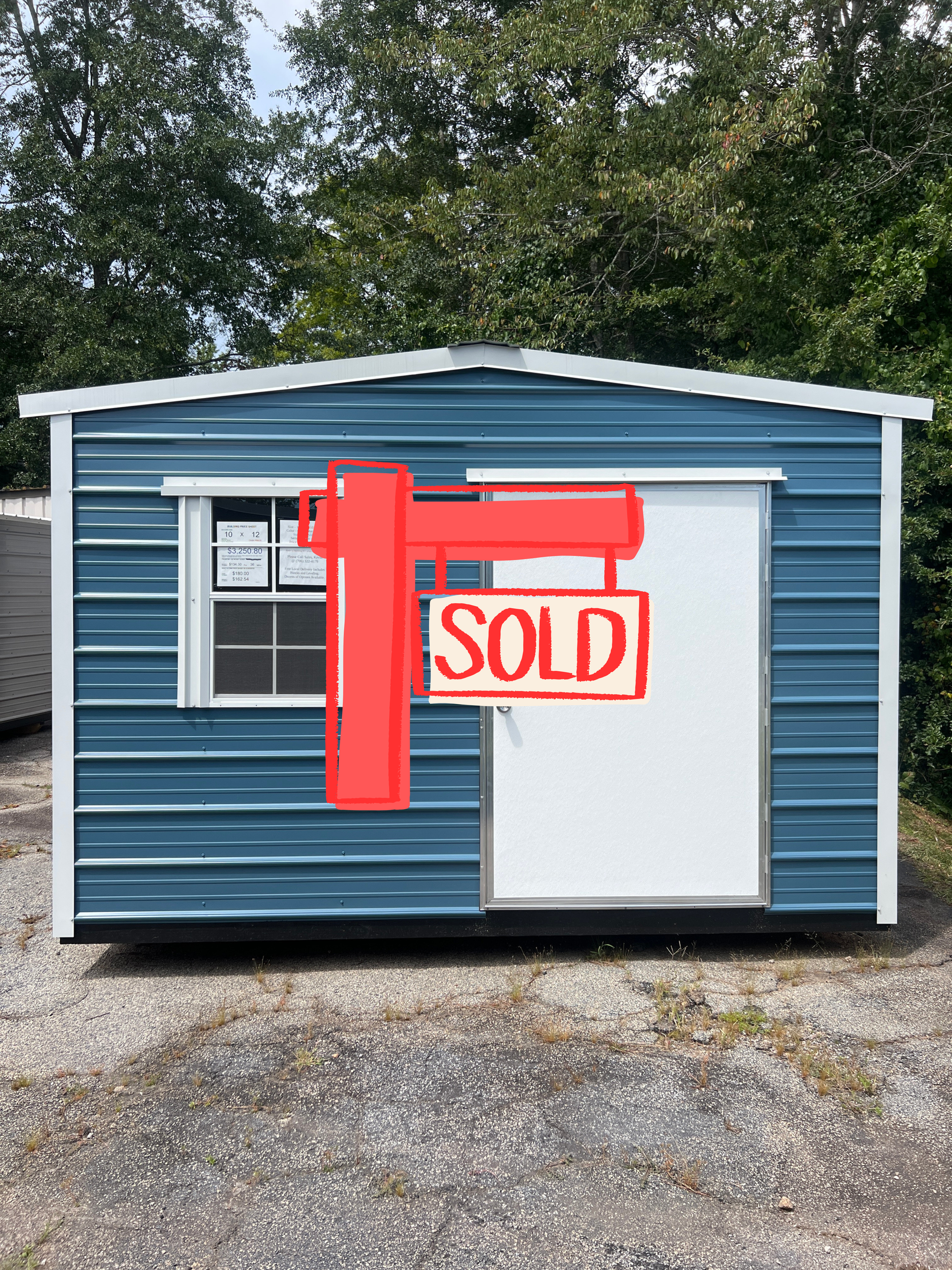 Blue and white metal shed with door and window, outdoors.