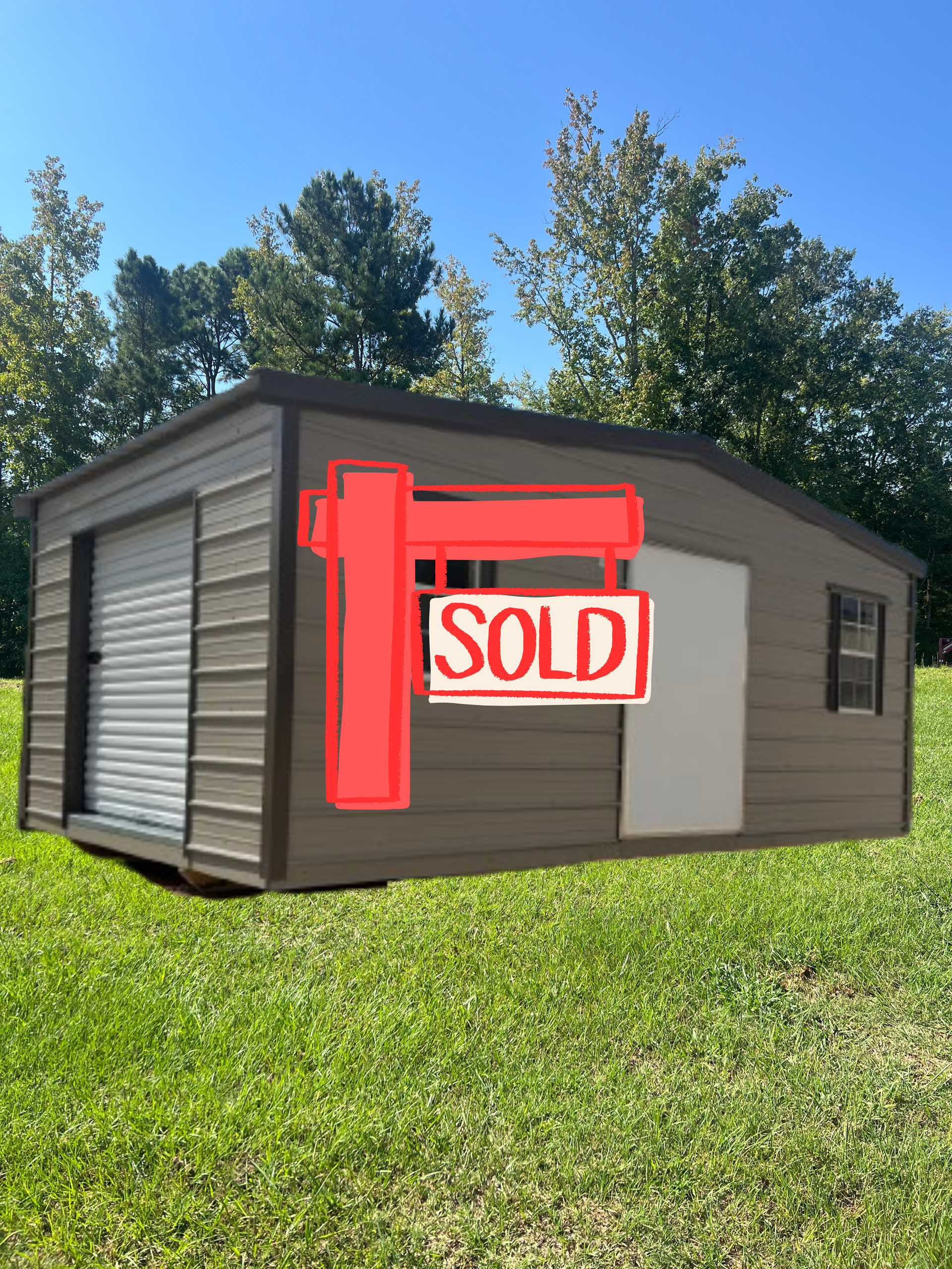 Tan storage shed with a roll-up side door, a standard door, and two windows, set on a grassy lawn under a blue sky.