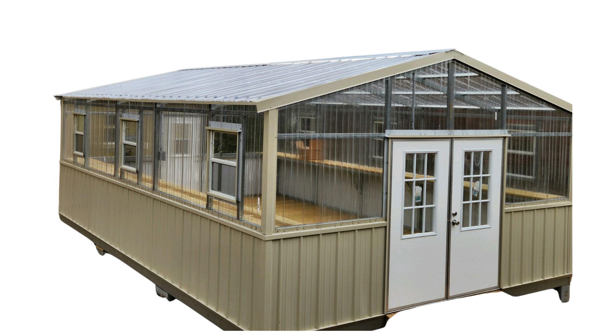 A greenhouse with a lot of windows and doors on a white background.