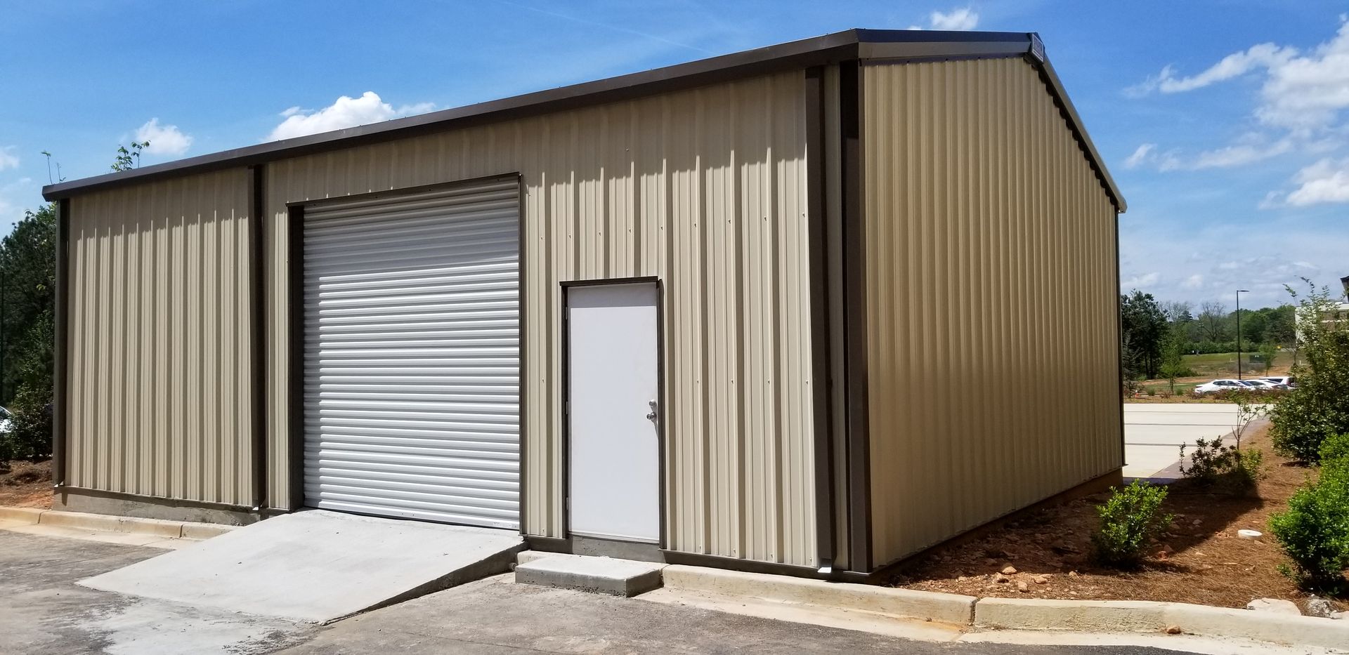 A large metal building with a cover in the middle of a field.