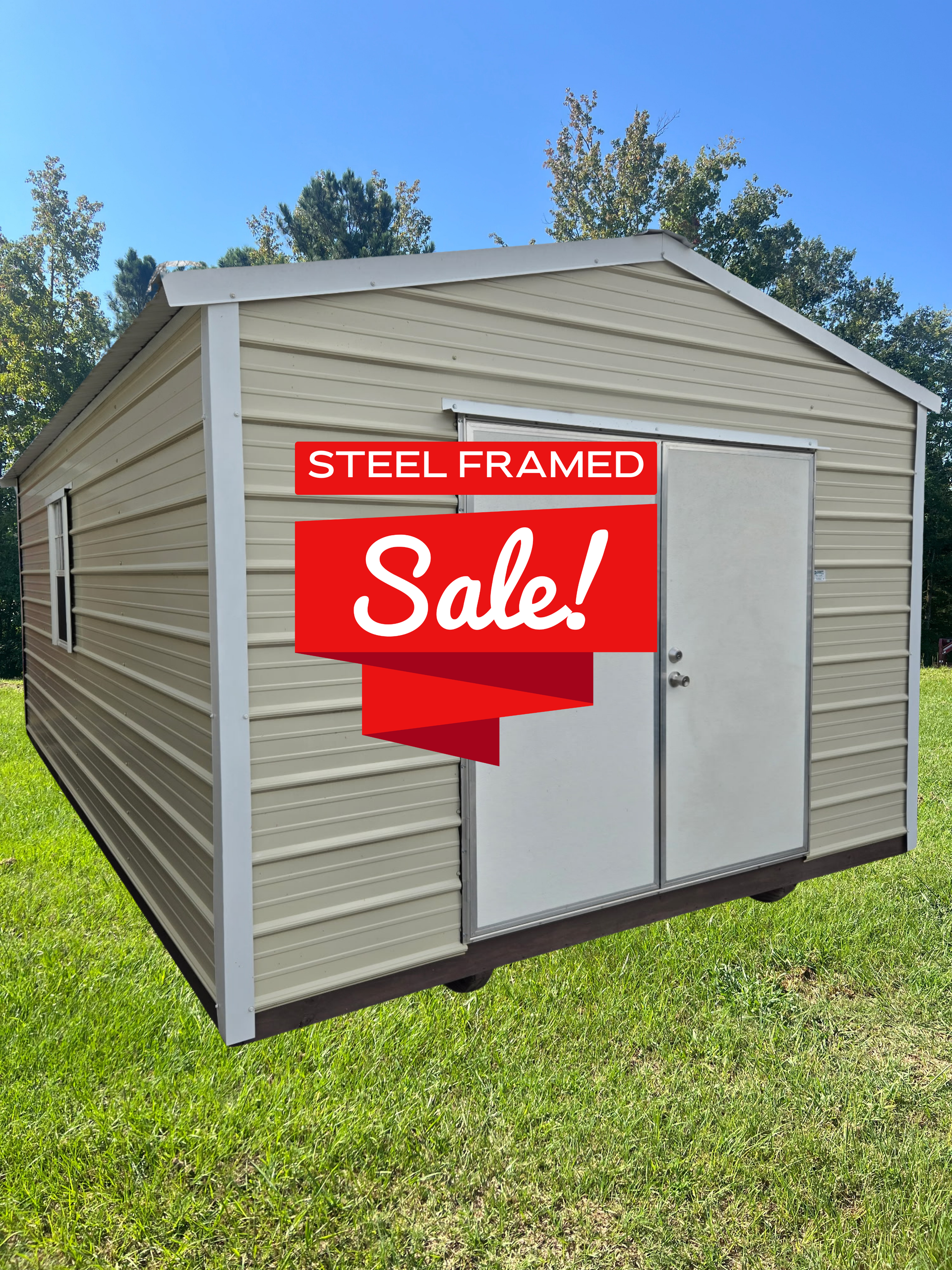 A beige, steel-framed storage shed with double doors sits on a green lawn against a clear blue sky, featuring a sale sign.